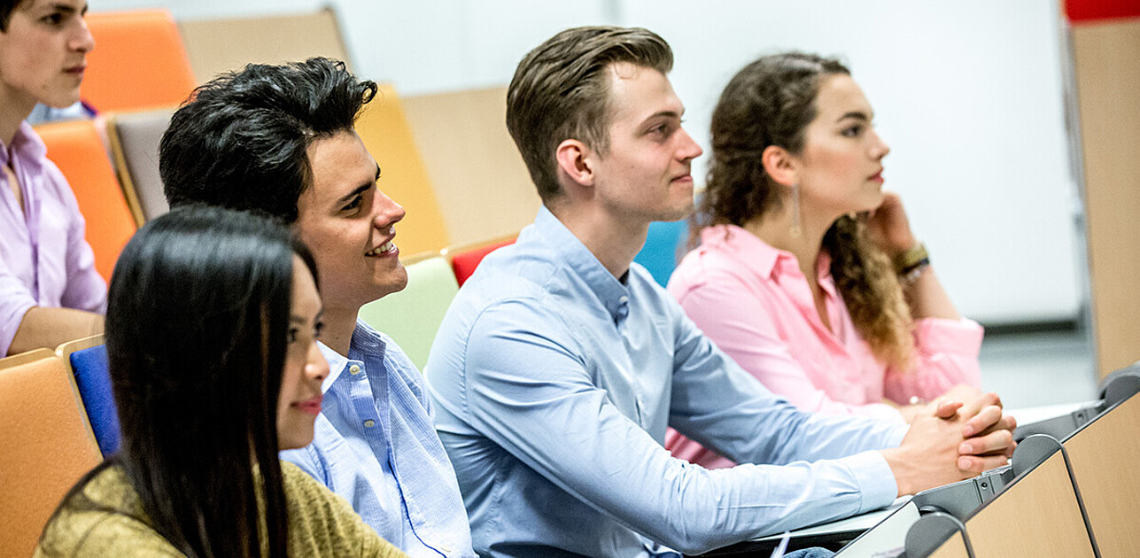 4 students sitting in a classroom