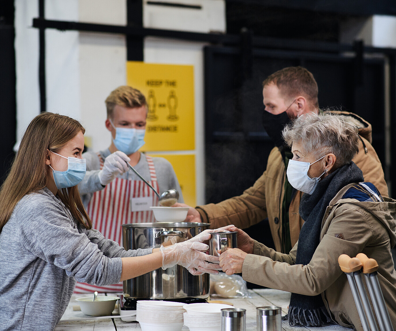 people handing out free meals in masks