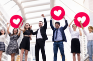 A group of people holding up hearts