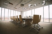 a boardroom with empty chairs