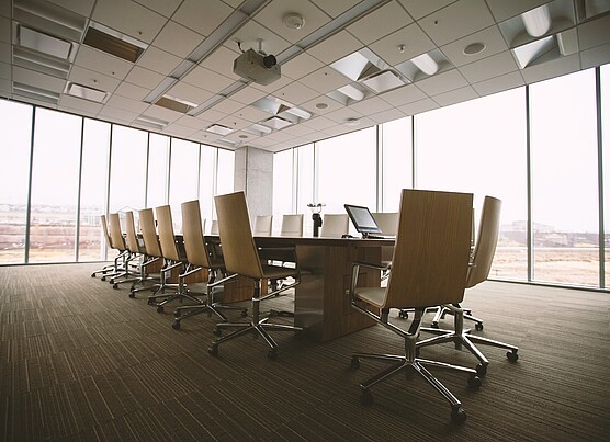 a boardroom with empty chairs