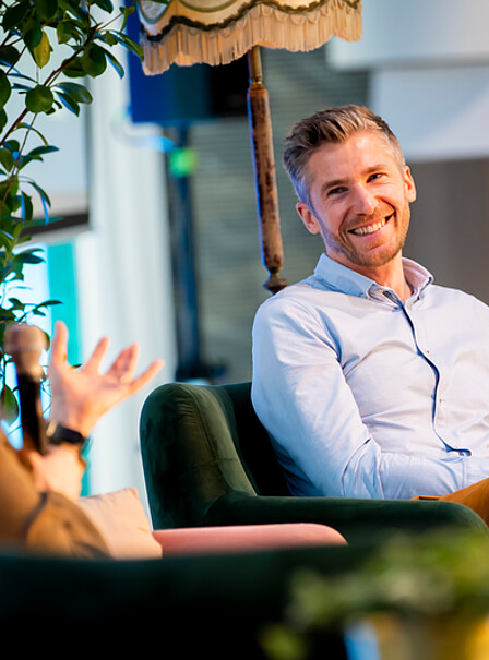 Two dedicated alumni engage in a heartfelt conversation about the latest advancements at Rotterdam School of Management during a joyful reunion