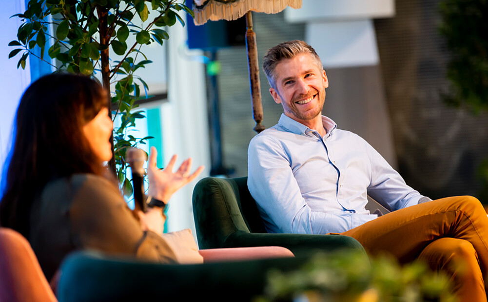 Two dedicated alumni engage in a heartfelt conversation about the latest advancements at Rotterdam School of Management during a joyful reunion