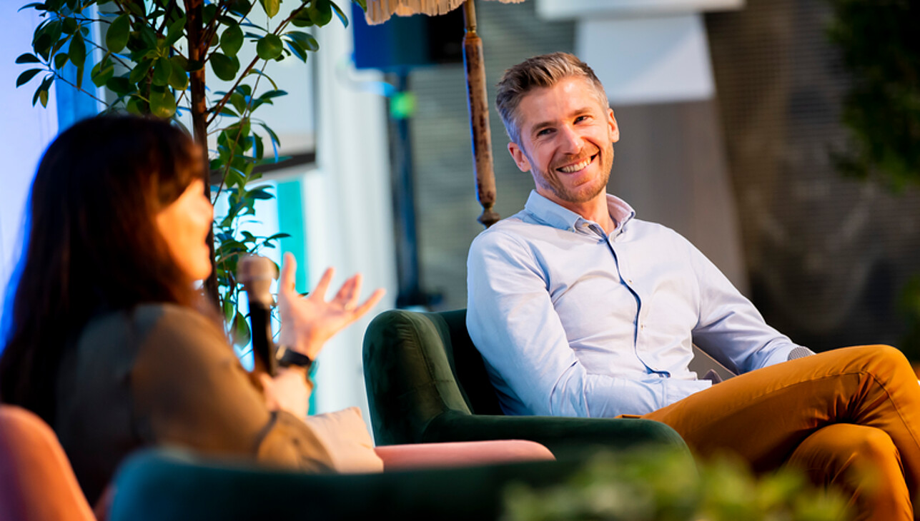 Two dedicated alumni engage in a heartfelt conversation about the latest advancements at Rotterdam School of Management during a joyful reunion