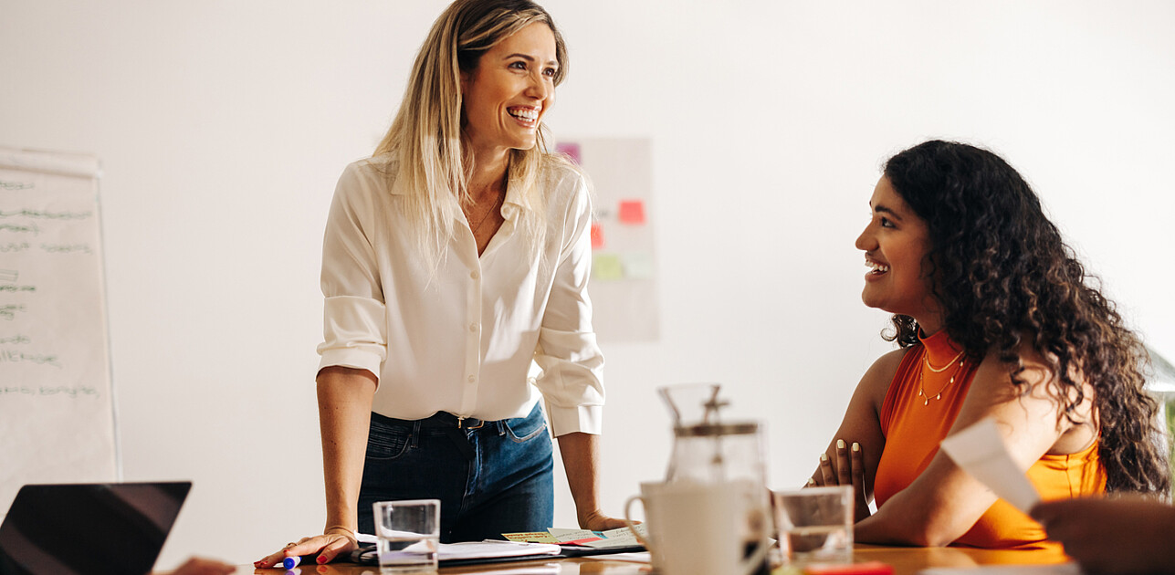 Image of a passionate leader enthusiastically brainstorming with her engaged team, radiating positivity and collaboration.