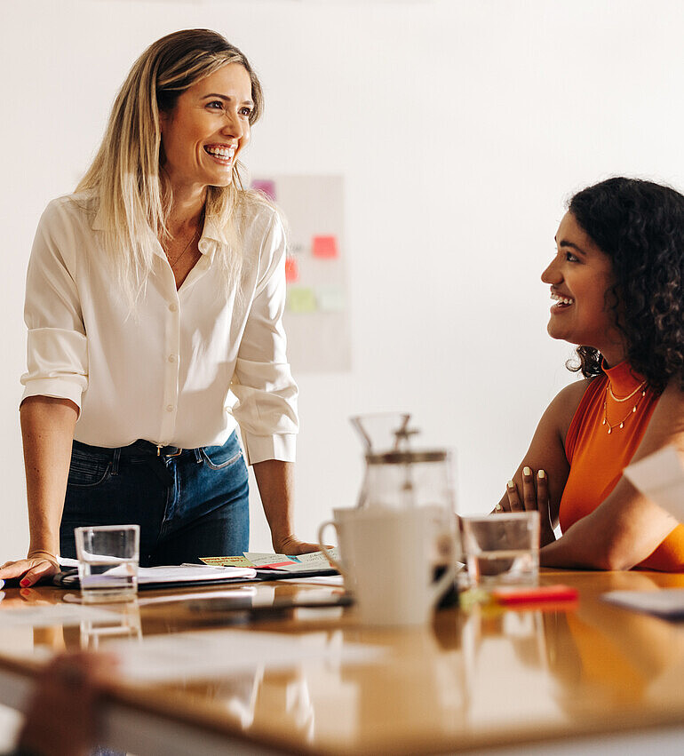 Image of a passionate leader enthusiastically brainstorming with her engaged team, radiating positivity and collaboration.