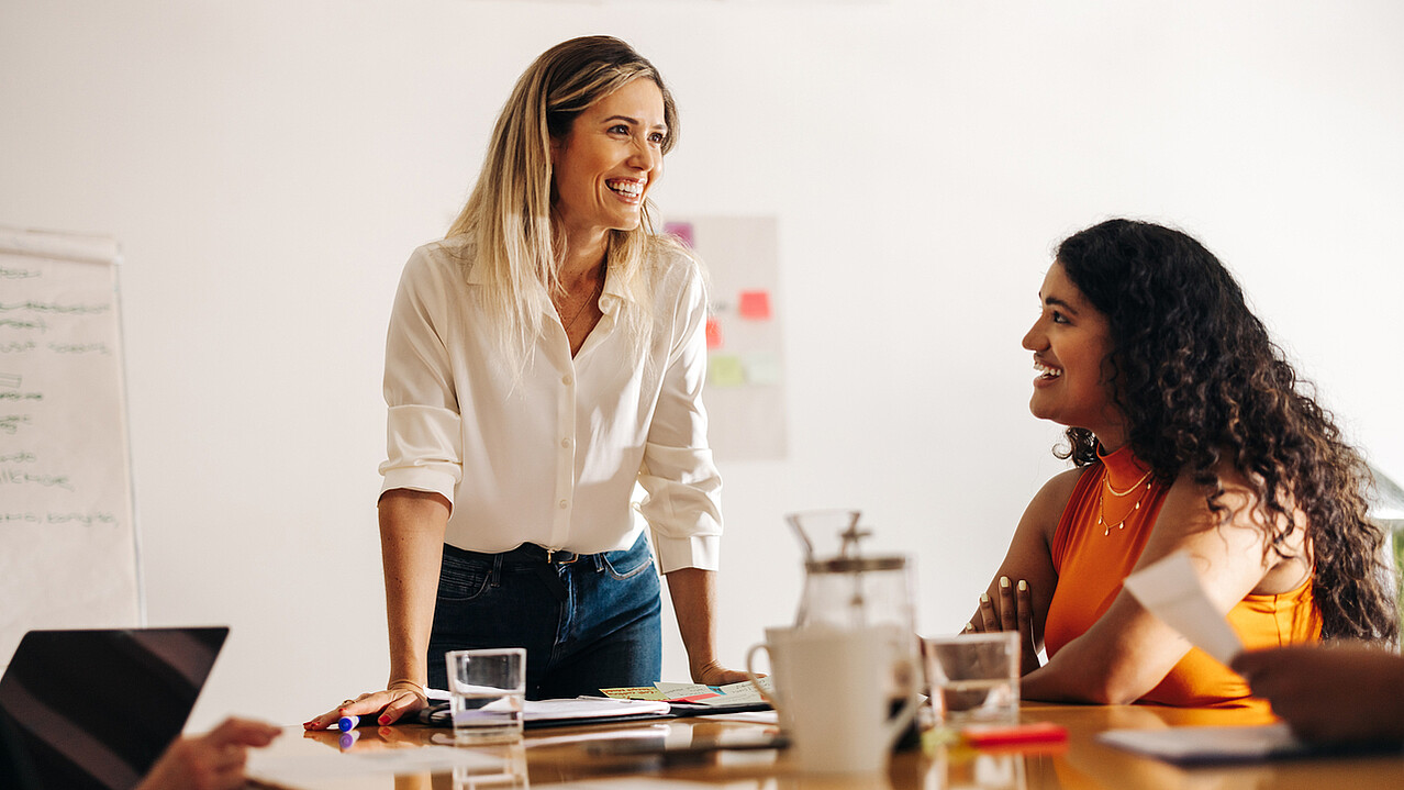 Image of a passionate leader enthusiastically brainstorming with her engaged team, radiating positivity and collaboration.