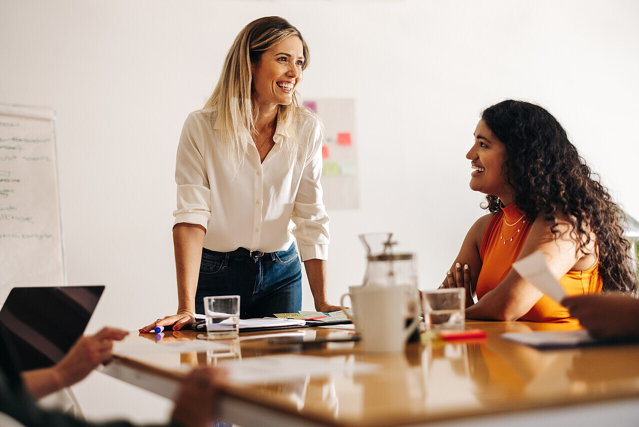 Image of a passionate leader enthusiastically brainstorming with her engaged team, radiating positivity and collaboration.