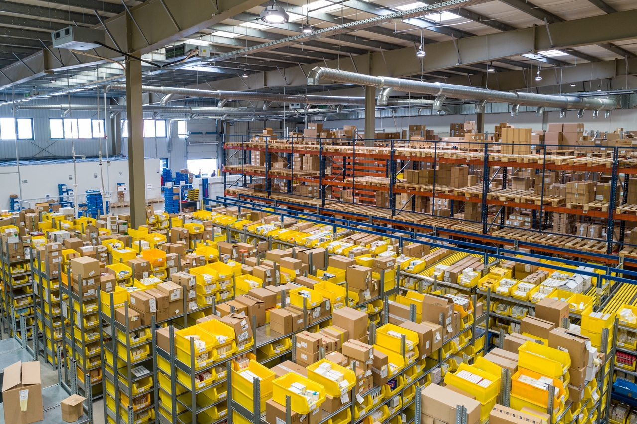 Warehouse interior filled with stacked cardboard boxes.